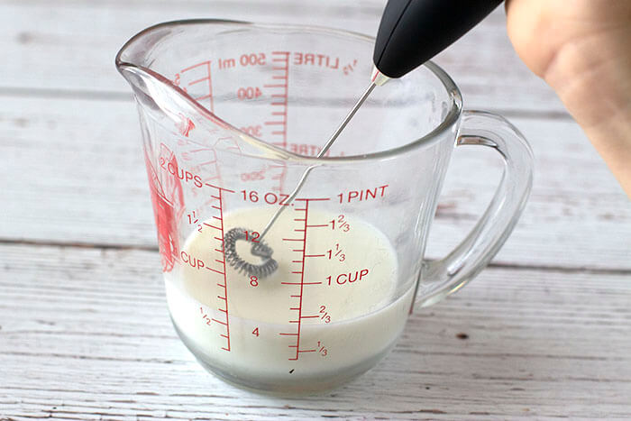 milk in cup with frother